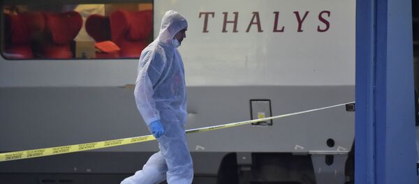 Police walk on a platform next to a Thalys train of French national railway operator SNCF at the main train station in Arras, northern France, on August 21, 2015 Police walk on a platform next to a Thalys train of French national railway operator SNCF at the main train station in Arras, northern France, on August 21, 2015 - Sputnik International