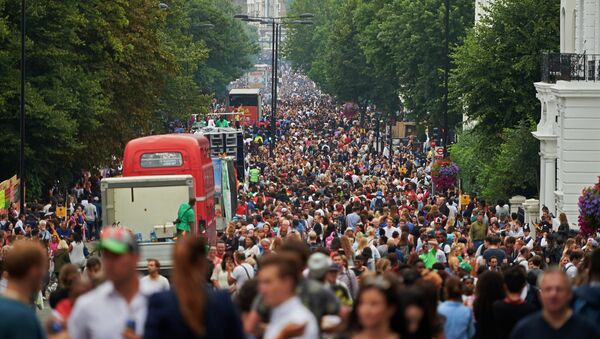 Visitors line the streets of Ladbrooke Grove as the carnical floats pass by on the first day of the Notting Hill Carnival in west London on August 30, 2015 - Sputnik International