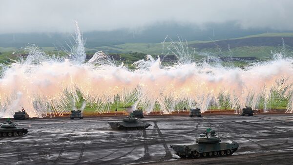 Japan Ground Self-Defense Force's Type-89 armored combat vehicles flare up a smoke screen during an annual live firing exercise at Higashi Fuji range in Gotemba, southwest of Tokyo. - Sputnik International