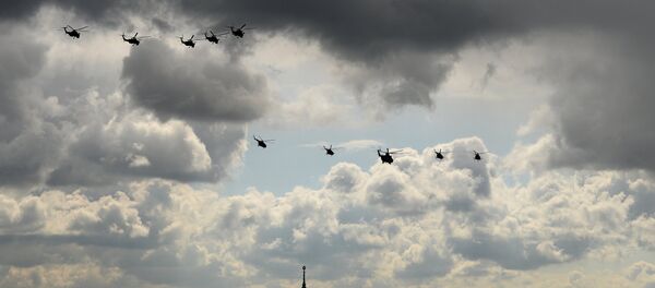 Mi 28 helicopters, military transport helicopter Mi 26, third from right, and MI 8 helicopters during a full dress rehearsal of the V-Day Parade on Red Square, Moscow. - Sputnik International