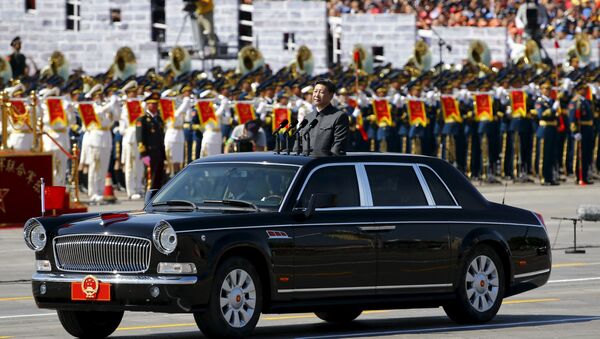 Chinese President Xi Jinping stands in a car on his way to review the army as military band members play next to him, at the beginning of the military parade marking the 70th anniversary of the end of World War Two, in Beijing, China, September 3, 2015 - Sputnik International