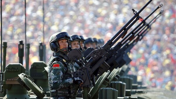 In this file photo soldiers of the People's Liberation Army (PLA) of China arrive on their armoured vehicles at Tiananmen Square during the military parade marking the 70th anniversary of the end of World War Two, in Beijing, China, September 3, 2015 - Sputnik International