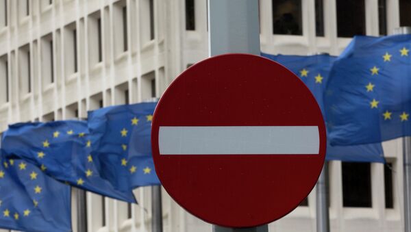 In this photo taken on Monday, March 30, 2015 EU flags flap in the wind behind a no entry traffic sign in front of EU headquarters in Brussels - Sputnik International