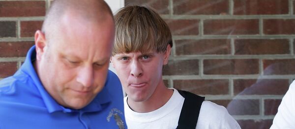 FILE - In this June 18, 2015, file photo, Charleston, S.C., shooting suspect Dylann Storm Roof, center, is escorted from the Sheby Police Department in Shelby, N.C. FILE - In this June 18, 2015, file photo, Charleston, S.C., shooting suspect Dylann Storm Roof, center, is escorted from the Sheby Police Department in Shelby, N.C. - Sputnik International