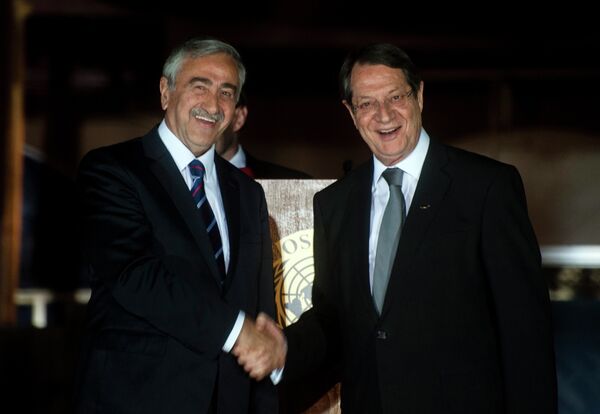 Cypriot President Nicos Anastasiades (R) shakes the hand of Turkish Cypriot President of the self-proclaimed Turkish Republic of Northern Cyprus (TRNC), Mustafa Akinci, following a UN-sponsored meeting at Ledra palace on May 11, 2015 - Sputnik International