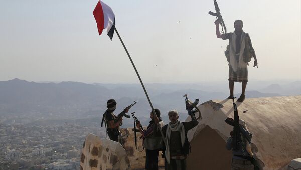 Fighters loyal to Yemen's exiled President Abedrabbo Mansour Hadi stand on top of the Al-Qahira Castle, located on the highest mountain in Yemen's third city Taez, after they seized it from rebel fighters on August 18, 2015. - Sputnik International