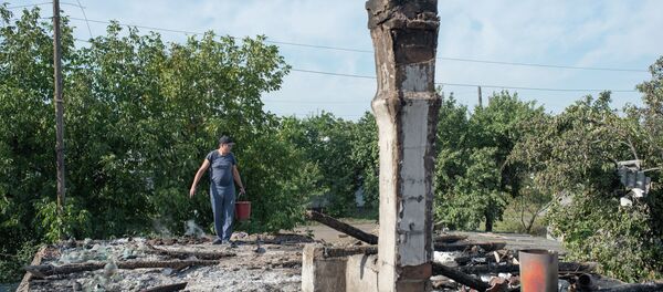 A man in the village of Oleksandrivka, Donetsk Region where houses were destroyed and people wounded during a mortar shelling. A man in the village of Oleksandrivka, Donetsk Region where houses were destroyed and people wounded during a mortar shelling. - Sputnik International