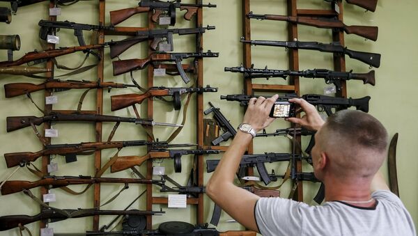 A visitor takes picture of weapons at an exhibition at Phaeton museum in Zaporizhia, Ukraine, August 11, 2015 - Sputnik International