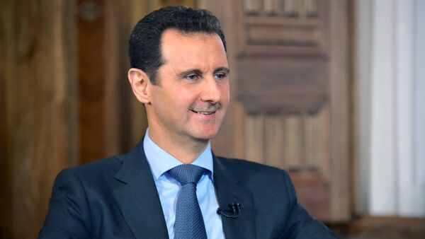 Syria's President Bashar al-Assad answers questions during an interview with al-Manar's journalist Amro Nassef, in Damascus, Syria, in this handout photograph released by Syria's national news agency SANA on August 25, 2015 - Sputnik International