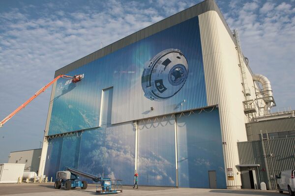 This Friday, Sept. 4, 2015 photo made available by NASA shows a mural depicting Boeing's newly named CST-100 Starliner commercial crew transportation spacecraft on the company's Commercial Crew and Cargo Processing Facility at NASA's Kennedy Space Center in Florida This Friday, Sept. 4, 2015 photo made available by NASA shows a mural depicting Boeing's newly named CST-100 Starliner commercial crew transportation spacecraft on the company's Commercial Crew and Cargo Processing Facility at NASA's Kennedy Space Center in Florida - Sputnik International