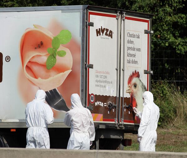 Investigators stand near a truck that stands on the shoulder of the highway A4 near Parndorf south of Vienna, Austria, Thursday, Aug 27, 2015 Investigators stand near a truck that stands on the shoulder of the highway A4 near Parndorf south of Vienna, Austria, Thursday, Aug 27, 2015 - Sputnik International