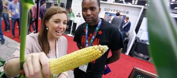 FILE- In this March 16, 2015, file photo, Chelsea Robinson of Monsanto answers questions from about corn for Mboswobeni Mulugana of Johannesburg, South Africa at the GMO Answers booth in Austin, Texas FILE- In this March 16, 2015, file photo, Chelsea Robinson of Monsanto answers questions from about corn for Mboswobeni Mulugana of Johannesburg, South Africa at the GMO Answers booth in Austin, Texas - Sputnik International