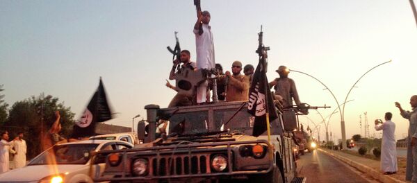 In this photo taken Monday, June 23, 2014, fighters from the Islamic State group parade in a commandeered Iraqi security forces armored vehicle down a main road at the northern city of Mosul, Iraq - Sputnik International