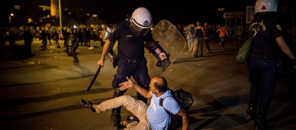 A migrant is confronted by a riot policeman during a protest in which hundreds of migrants and refugees demanded the authorities to let them go to Athens and continue their trip towards Northern Europe, at the port of Mytilene, on the northeastern Greek island of Lesbos, on Saturday, Sept. 5, 2015 A migrant is confronted by a riot policeman during a protest in which hundreds of migrants and refugees demanded the authorities to let them go to Athens and continue their trip towards Northern Europe, at the port of Mytilene, on the northeastern Greek island of Lesbos, on Saturday, Sept. 5, 2015 - Sputnik International