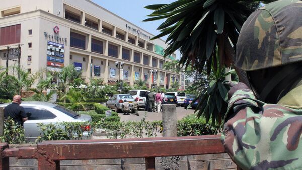A soldier aims his weapon outside the Westgate Mall, an upscale shopping mall in Nairobi, Kenya Saturday Sept. 21 2013, where shooting erupted when armed men staged an attack. - Sputnik International