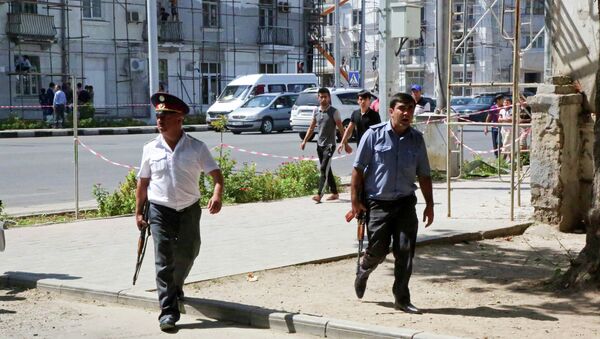 Police officers secure an area in the capital of Tajikistan, Dushanbe, where several Interior Ministry special forces officers and a traffic policeman were reportedly shot dead earlier on Friday, Sept. 4, 2015 - Sputnik International