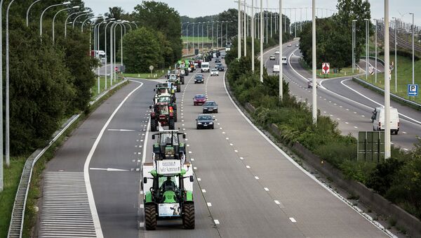 Farmers drive their tractors in a line down a main motorway outside of Brussels, Belgium on Sunday, Sept. 6, 2015. Farmers are expected to demonstrate in Brussels on Monday, Sept. 7, 2015 - Sputnik International