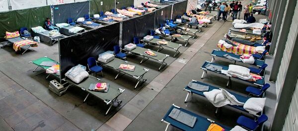 Refugees and migrants arrive in their accommodation, the exhibition halls of the Trade Fair Messe Erfurt, in Erfurt, central Germany, Tuesday, Sept. 8, 2015. The city of Erfurt expect up to 600 migrants to arrive within some hours. Refugees and migrants arrive in their accommodation, the exhibition halls of the Trade Fair Messe Erfurt, in Erfurt, central Germany, Tuesday, Sept. 8, 2015. The city of Erfurt expect up to 600 migrants to arrive within some hours. - Sputnik International