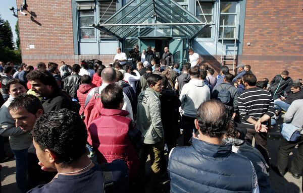 People wait outside a registration center for migrants and refugees in Berlin, Germany, Thursday, Sept. 10, 2015. People wait outside a registration center for migrants and refugees in Berlin, Germany, Thursday, Sept. 10, 2015. - Sputnik International