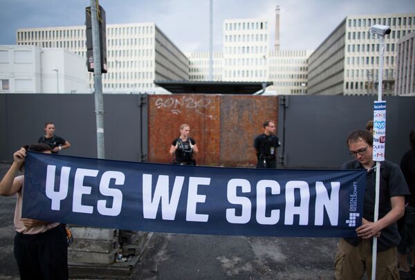 Demonstrators hold a banner during a protest against the supposed surveillance by the US National Security Agency, NSA, and the German intelligence agency, BND, during a rally in front of the construction site of the new headquarters of German intelligence agency in Berlin, Germany, Monday July 29, 2013. - Sputnik International