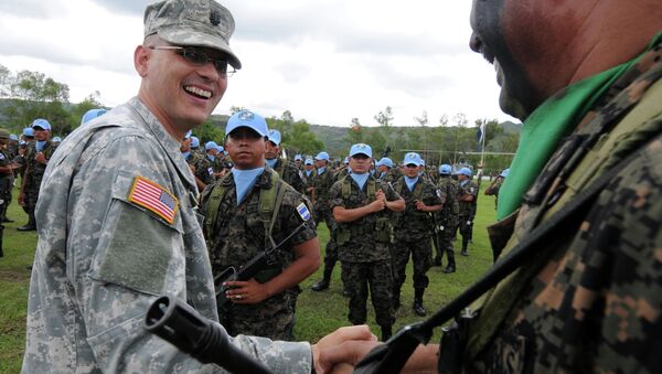An unidentified US military (L) says goodbye to a Honduran soldier. - Sputnik International
