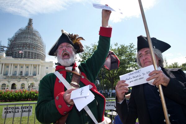Rally attendees hold up names and phone numbers of legislators who are in support of the Iran deal. - Sputnik International