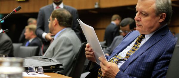 Russia's ambassador to the International Atomic Energy Agency (IAEA) Grigory Berdennikov reads documents as he attends the Board of Governors meeting at the UN atomic agency headquarters in Vienna on September 11, 2013 - Sputnik International