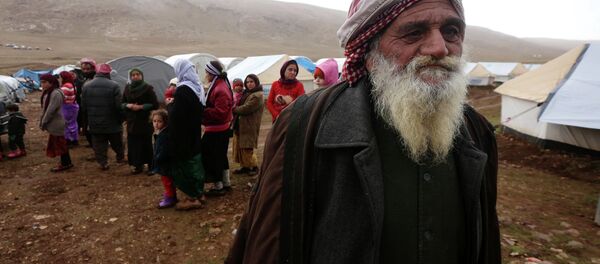 Displaced Iraqi people from the Yazidi community, who fled violence between Islamic State (IS) group jihadists and Peshmerga fighters in the northern Iraqi town of Sinjar, gather around their tents at a refugee camp set up on Mount Sinjar on January 15, 2015 Displaced Iraqi people from the Yazidi community, who fled violence between Islamic State (IS) group jihadists and Peshmerga fighters in the northern Iraqi town of Sinjar, gather around their tents at a refugee camp set up on Mount Sinjar on January 15, 2015 - Sputnik International