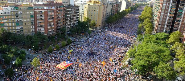 Demonstrators gather on Meridiana street as they wave Estelada flags (pro-independence Catalan flags) during celebrations of Catalonia's National Day (Diada) which recalls the final defeat of local troops by Spanish king Philip V's forces in 1714, in Barcelona on September 11, 2015 - Sputnik International