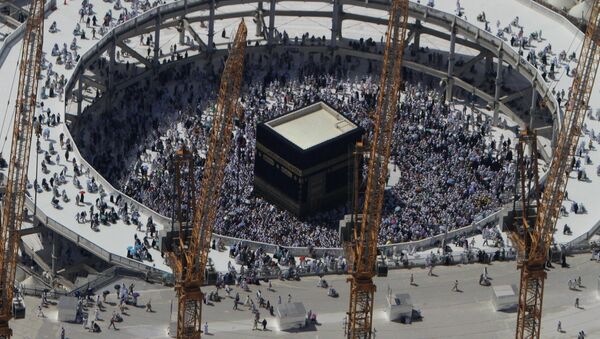Cranes rise at the site of an expansion to the Grand Mosque as Muslim pilgrims circle counterclockwise around the Kaaba at the Grand Mosque in Mecca, Saudi Arabia, Wednesday, Oct. 16, 2013 - Sputnik International