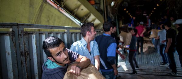 Unloading Russian plane with humanitarian aid which arrived to Latakia Airport in Syria. File photo - Sputnik International