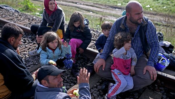 Migrants take a rest after crossing into the country from Serbia at the border near Roszke, Hungary September 12, 2015 - Sputnik International