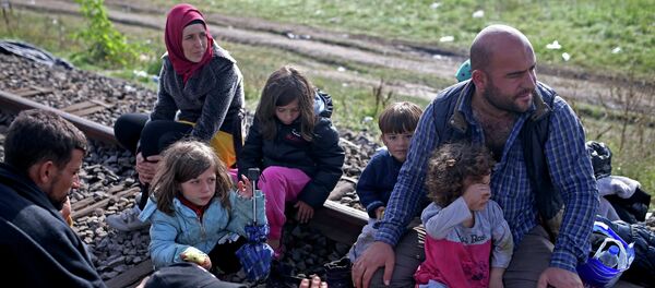 Migrants take a rest after crossing into the country from Serbia at the border near Roszke, Hungary September 12, 2015 Migrants take a rest after crossing into the country from Serbia at the border near Roszke, Hungary September 12, 2015 - Sputnik International