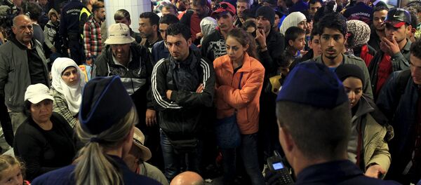 Migrants, who mostly crossed into the country from Serbia and are hoping to make their way to Austria, wait for trains heading to Hegyeshalom or Gyor, in a transit area at Keleti station in Budapest, Hungary, September 12, 2015 Migrants, who mostly crossed into the country from Serbia and are hoping to make their way to Austria, wait for trains heading to Hegyeshalom or Gyor, in a transit area at Keleti station in Budapest, Hungary, September 12, 2015 - Sputnik International