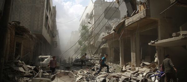 Syrians walk amid the rubble of destroyed buildings following reported air strikes by regime forces in the rebel-held area of Douma, east of the capital Damascus, on August 30, 2015 Syrians walk amid the rubble of destroyed buildings following reported air strikes by regime forces in the rebel-held area of Douma, east of the capital Damascus, on August 30, 2015 - Sputnik International