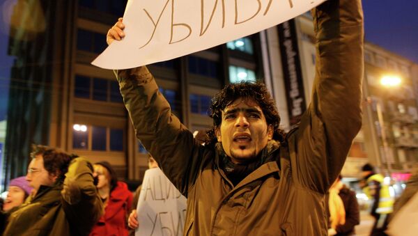 Protestor holds a poster reading Keeping silence might kill, as he shouts slogans during a flash mob demonstration by refugees and migrants that has closed the main street to traffic, in Sofia, Bulgaria, Friday, Feb. 25, 2011 - Sputnik International