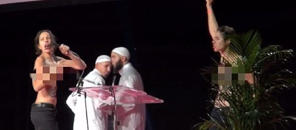 Two topless feminists storm Muslim conference stage in France Two topless feminists storm Muslim conference stage in France - Sputnik International