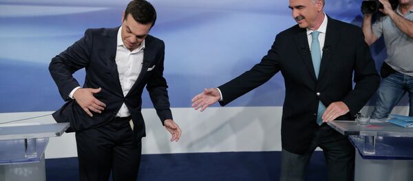 Former Greek Prime Minister Alexis Tsipras, left, and the leader of the left-wing Syriza party, is blocked by microphone wiring as he tries to approach main opposition conservative New Democracy head Vangelis Meimarakis, right, to shake hands prior to a live televised debate at the state-run ERT television in Athens, Monday, Sept. 14, 2015. Greece is holding a snap general election on Sept. 20, 2015. - Sputnik International