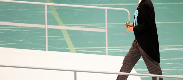 Japanese Prime Minister Shinzo Abe walks towards the main altar decorated with huge bank of chrysanthemums as he offers prayers for the war dead during a memorial service at Nippon Budokan martial arts hall in Tokyo, Saturday, Aug. 15, 2015. Japanese Prime Minister Shinzo Abe walks towards the main altar decorated with huge bank of chrysanthemums as he offers prayers for the war dead during a memorial service at Nippon Budokan martial arts hall in Tokyo, Saturday, Aug. 15, 2015. - Sputnik International