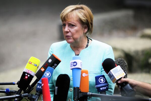 German Chancellor Angela Merkel, speaks to media after a visit of a so called 'Welcome Class', a special school class for migrants and refugees at the Ferdinand-Freiligrath school in Berlin, Germany, Thursday, Sept. 10, 2015. German Chancellor Angela Merkel, speaks to media after a visit of a so called 'Welcome Class', a special school class for migrants and refugees at the Ferdinand-Freiligrath school in Berlin, Germany, Thursday, Sept. 10, 2015. - Sputnik International