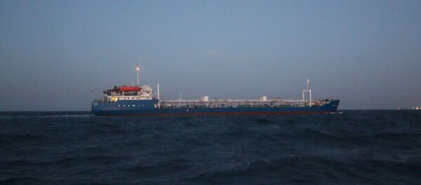A Russian-flagged oil tanker is seen in Tripoli Naval Base after coast guard of the central region guards captured it A Russian-flagged oil tanker is seen in Tripoli Naval Base after coast guard of the central region guards captured it - Sputnik International