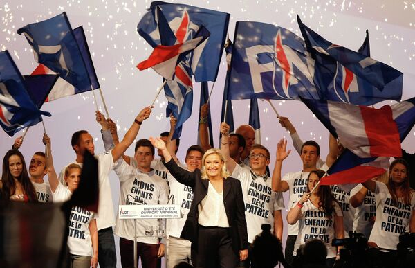 France’s far-right National Front president Marine Le Pen, center, surrounded by members, waves to supporters after her speech during their meeting in Marseille, southern France, Saturday, Sep. 6, 2015. France’s far-right National Front president Marine Le Pen, center, surrounded by members, waves to supporters after her speech during their meeting in Marseille, southern France, Saturday, Sep. 6, 2015. - Sputnik International