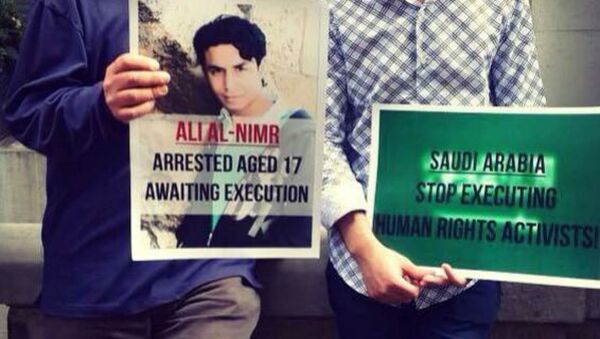 Demonstrators hold a picture of Ali Muhammed al-Nimr after his appeal case failed. - Sputnik International