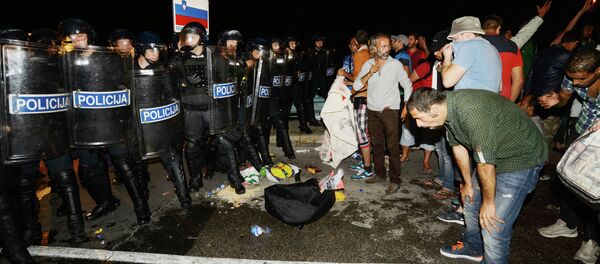 Migrants react after pepper spray was used in a small village of Rigonce in Slovenia, a small border crossing point to Harmica, Croatia, on September 18, 2015 Migrants react after pepper spray was used in a small village of Rigonce in Slovenia, a small border crossing point to Harmica, Croatia, on September 18, 2015 - Sputnik International
