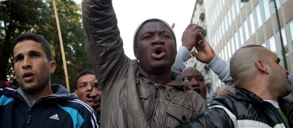 Refugees and their supporters demonstrate outside of a meeting of EU justice and interior ministers at the EU Council building in Brussels on Monday, Sept. 14, 2015 Refugees and their supporters demonstrate outside of a meeting of EU justice and interior ministers at the EU Council building in Brussels on Monday, Sept. 14, 2015 - Sputnik International
