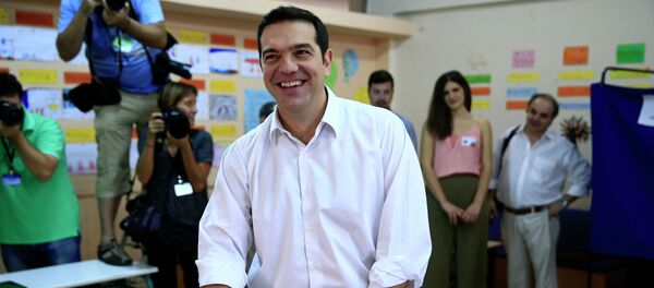 Leader of left-wing Syriza party and former Prime Minister Alexis Tsipras casts his vote at a polling station in Athens, Sunday, Sept. 20, 2015 - Sputnik International