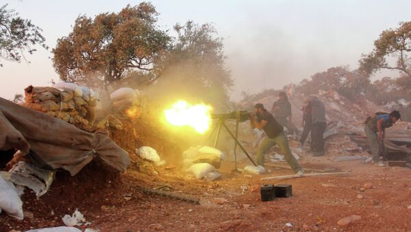 A rebel fighter fires heavy artillery during clashes with government forces and pro-regime shabiha militiamen in the outskirts of Syria's northwestern Idlib province on September 18, 2015 - Sputnik International
