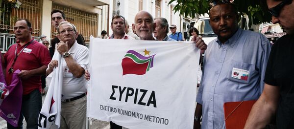 Supporters of the Greek radical-left Syriza party hold flags of the party as they wait for the left-wing leader and former minister Alexis Tsipras outside a polling station in central Athens on September 20, 2015 - Sputnik International