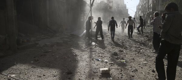 Residents inspect damage after what activists said was an airstrike by forces loyal to Syria's President Bashar al-Assad on the town of Douma, eastern Ghouta of Damascus September 19, 2015 Residents inspect damage after what activists said was an airstrike by forces loyal to Syria's President Bashar al-Assad on the town of Douma, eastern Ghouta of Damascus September 19, 2015 - Sputnik International