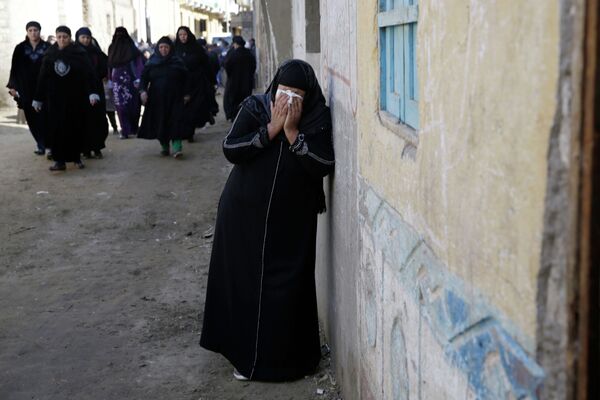 A woman mourns for the Egyptian Coptic Christians captured in Libya and killed by militants affiliated with the Islamic State group, outside of the Virgin Mary church in the village of el-Aour, near Minya, 220 kilometers (135 miles) south of Cairo, Egypt, Monday, Feb. 16, 2015 A woman mourns for the Egyptian Coptic Christians captured in Libya and killed by militants affiliated with the Islamic State group, outside of the Virgin Mary church in the village of el-Aour, near Minya, 220 kilometers (135 miles) south of Cairo, Egypt, Monday, Feb. 16, 2015 - Sputnik International